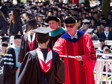 President Durden presenting a diploma to the latest graduating class. 