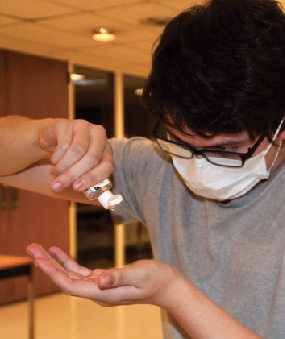 Leonard Bacon-Shone ’16 demonstrating items handed out in the Dickinson College Flu Kit. 