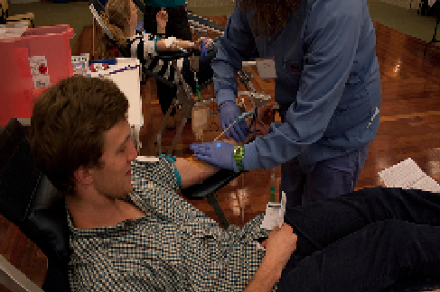 A student donates blood to the ROTC blood drive.