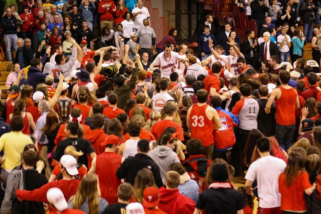 Fans swamp the players after waiting for the 
opponents from Marietta College to leave the court. 