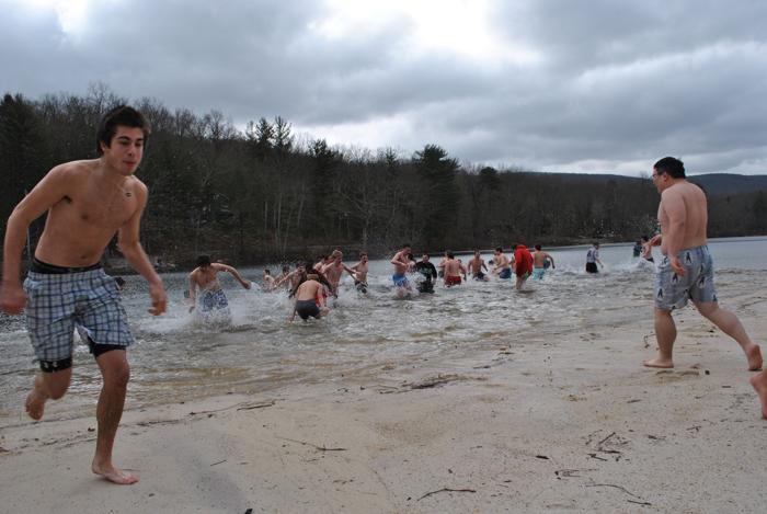 Students rush into the water for Delta Sigma Phi’s  annual Polar Bear Plunge philanthropy event. 
