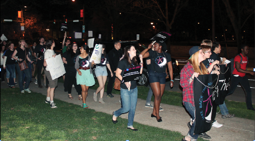 A crowd of men and women moving out of Old West and across the Academic Quad on April 17. The peaceful demonstration was part of the this year’s Take Back the Night event against rape and violence. 