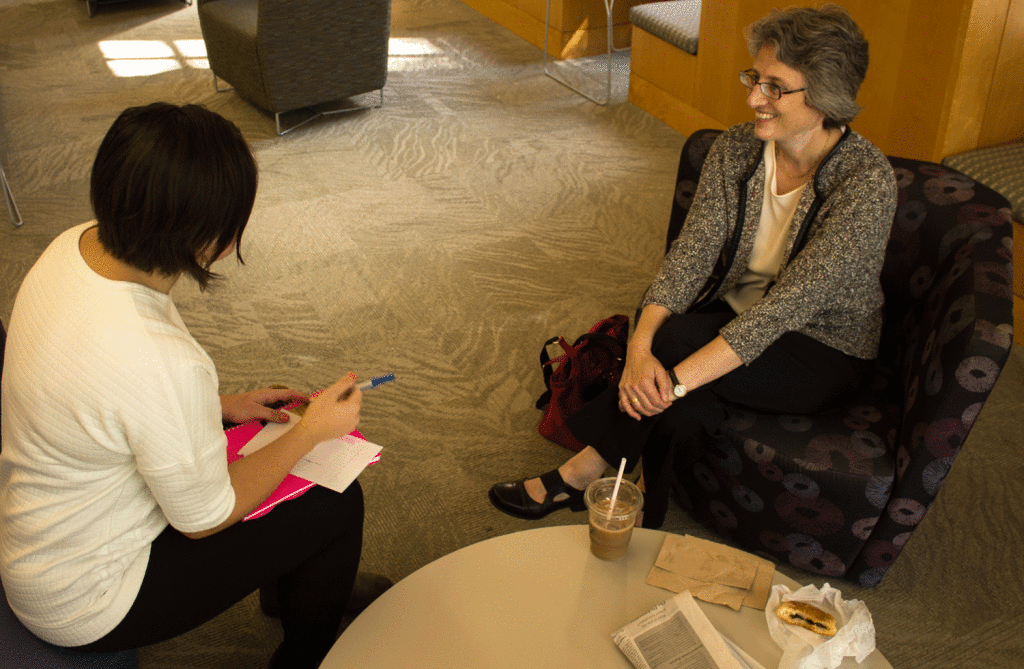 President Roseman talks to a student in the Biblio during her open office hours. 