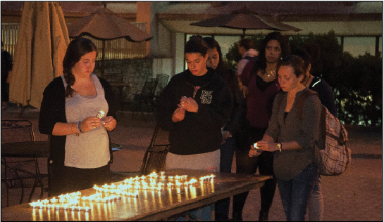 Students light candles at a vigil hosted by the organization J Street U, in remembrance of the lives ended in the conflict between Israel and Hamas.