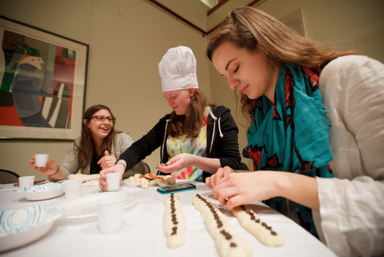 Kathleen Getaz ’17, Becca Lipset ’17 and Macey Cohen ’17 design and decorate their own challah bread in Stern.