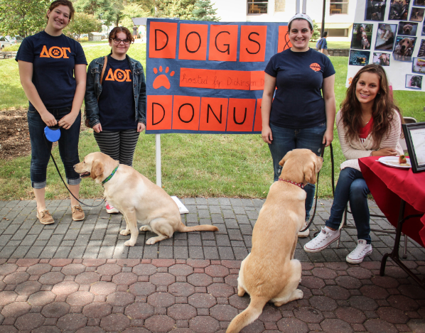 Members of the Dog House greet families and alumni on Britton Plaza on Sept. 26. 