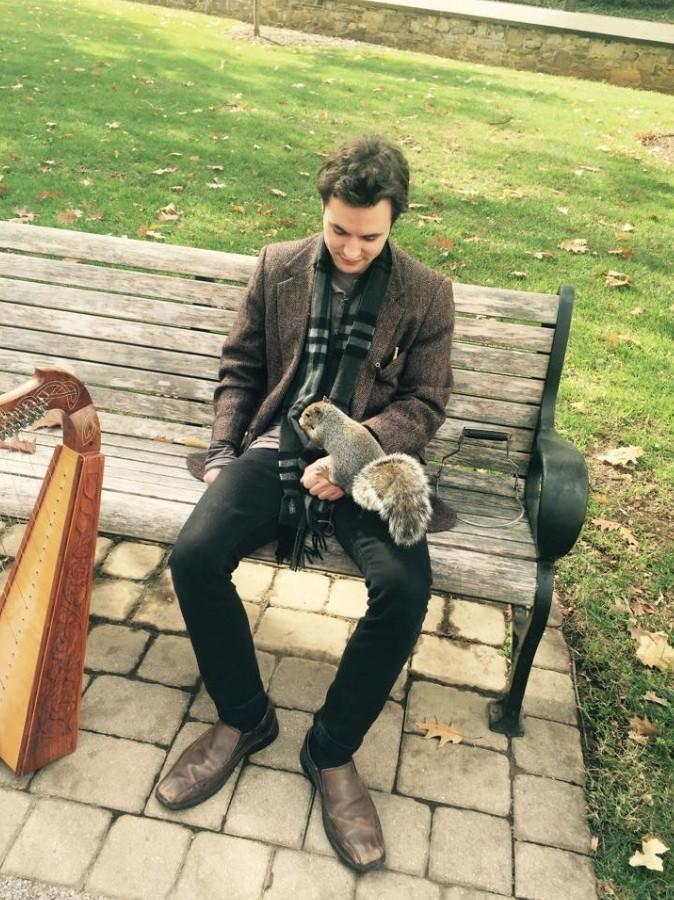 Maltz, who plays the harp and flute, communicates with a  squirrel on the academic quad.