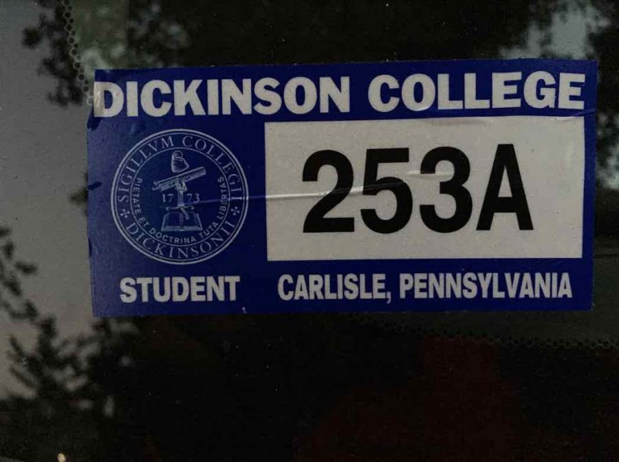 A parking sticker on a registered student car.  Vehicle registration in the DPS office has no cost.