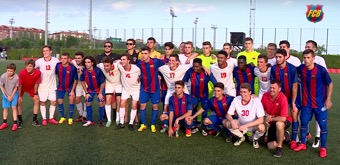 The Dickinson men’s soccer team poses with members of Futbol Club Barcelona.