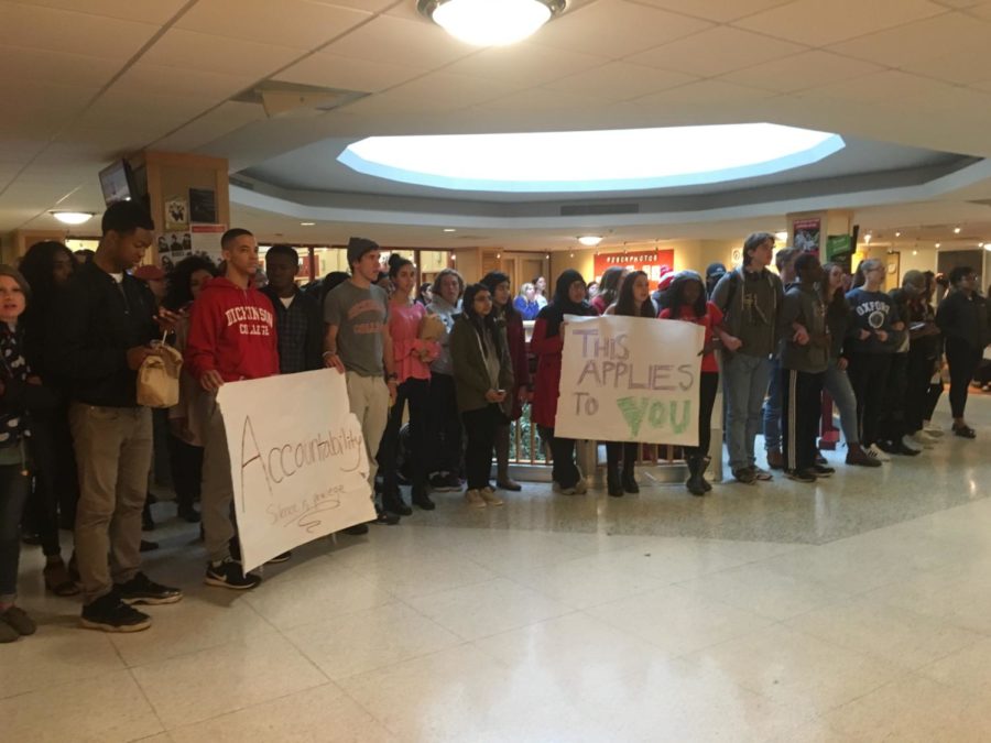Students held signs and linked arms outside of the Tuesday, Nov. 7 faculty meeting from 12 p.m. to 12:40 p.m., then moved the protest to the HUB stairwell.