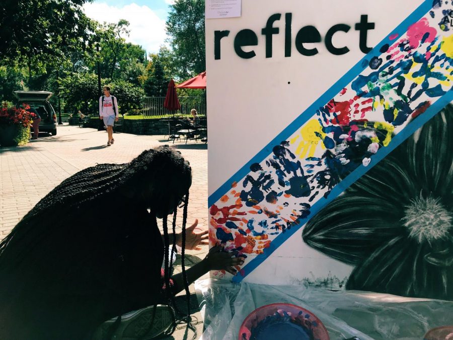 Local aritist Chris Varner working on the “multi-piece mural,” to which students could contribute.