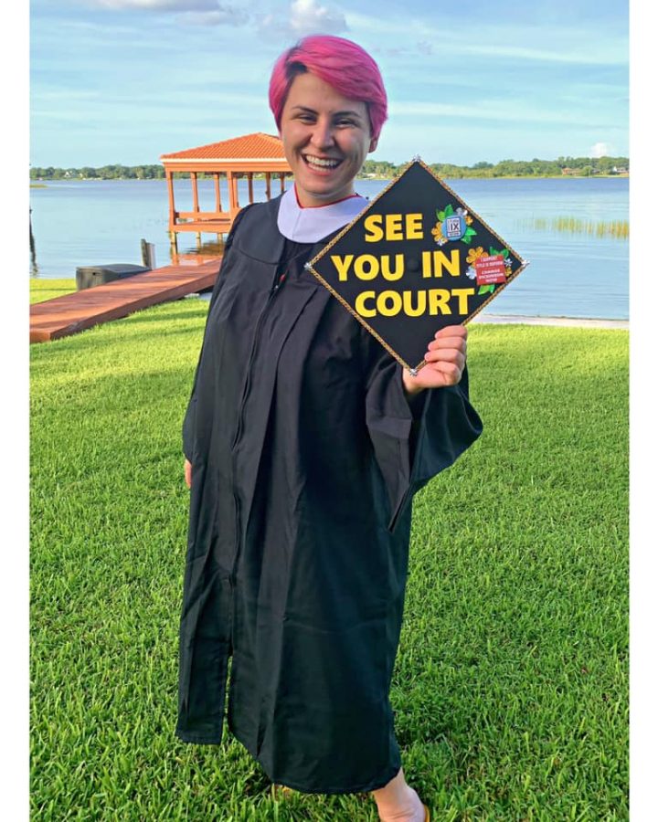 Rose McAvoy 20 poses with her graduation cap which has the phrase See You In Court on it, referencing the lawsuit.